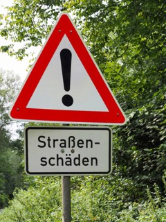 Traffic sign Attention with road damage, North Rhine-Westphalia, Germany, Europe