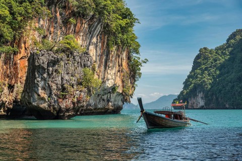 Tropical islands view with long tail boat and ocean blue sea water at Koh Lao Lading, Krabi