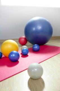 Balls stability and toning pilates sport gym on red yoga mat