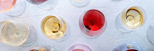 Wine glasses at a tasting panorama. Rose, red, and white wine, drinks, overhead flat lay shot. An