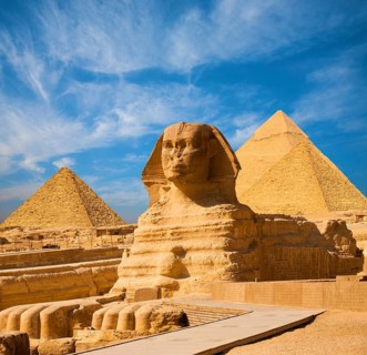 Egyptian Great Sphinx full body portrait with head, feet with all pyramids of Menkaure, Khafre,