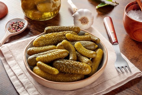 Pickled cucumbers with salt, pepper, garlic, and bay leaf. Fermented food. Homemade canned gherkins