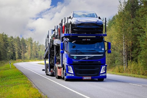 Blue Volvo FM car carrier Autolink Oy hauls Tesla and other new cars on road 25 from Hanko Port to