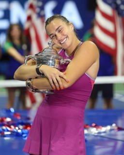 Tennis player Aryna Sabalenka hugging the trophy during the presentation at the US Open 2024