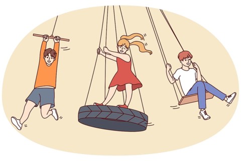 Happy children have fun riding on swings outdoors. Smiling kids enjoy summer leisure activity on