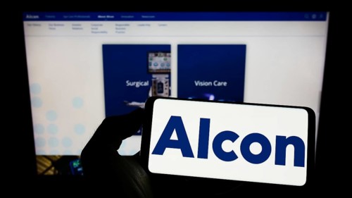 Stuttgart, Germany, 08-28-2022: Person holding cellphone with logo of eye care company Alcon AG on