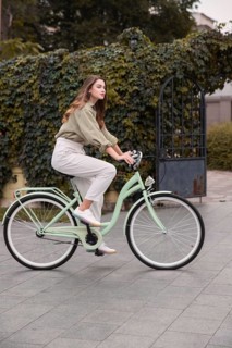 Side view woman city riding bicycle