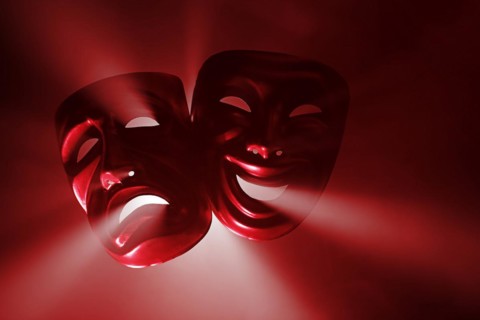 Crying and smiling masks in hazy light