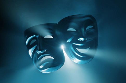 Crying and smiling masks in hazy light