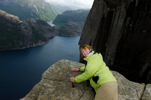 Woman at the edge of Preikestolen, Lysefjord, Jorpeland, Rogaland, Norway, Europe