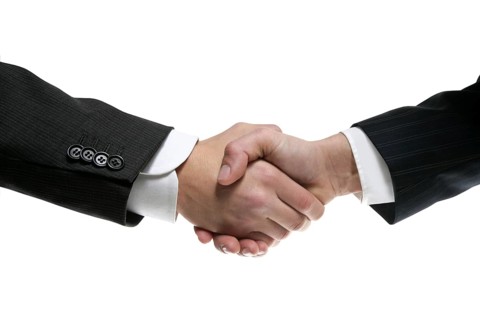 Businessman teamwork partners shaking hands with suit