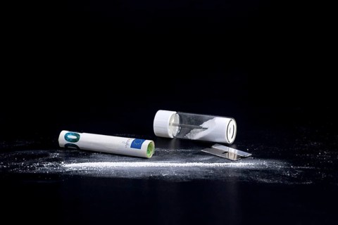 Cocaine Line and Razor Blade on a Black Background