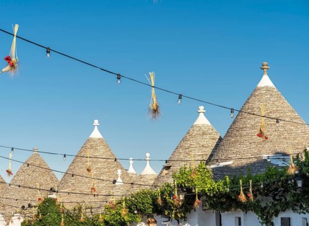 Sunshine on summer vacation in trulli town of Alberobello in Puglia, Italy, Europe