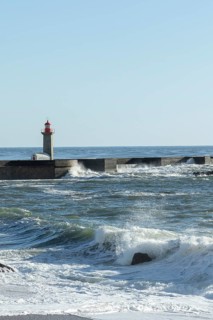 Farolim de Felgueiras lighthouse in the Atlantic Ocean and surf at Praia do Carneiro beach in Foz