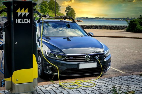 Volkswagen Passat GTE plug-in hybrid electric car charging battery at seaside Helen Charging Point.