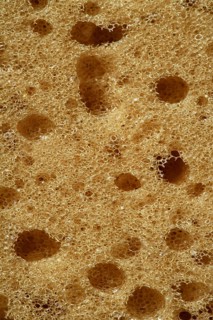 Orange sponge texture background, macro detail of surface