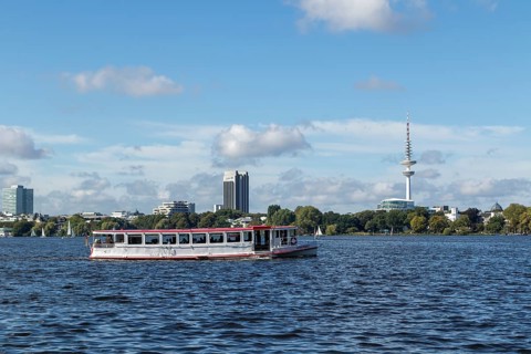 Leisure activities in summer, pedal boats and Alster-Touristik launch Ammersbek in front of blue