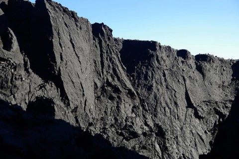 A mountain of coal dust eroded by water at a coal mine