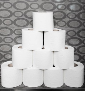 Close up stack toilet paper rolls shelf