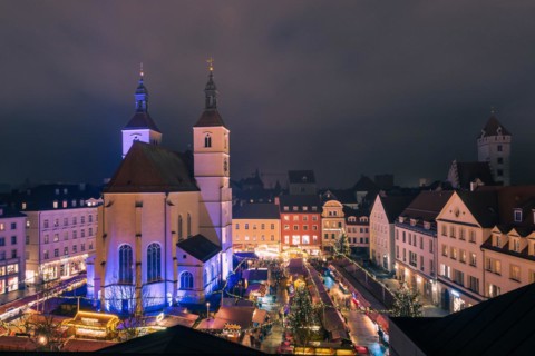 The traditional famous Christmas market on the Neupfarrplatz in Regensburg in December seen from