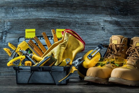 Big set of construction tools in little toolbox and boots