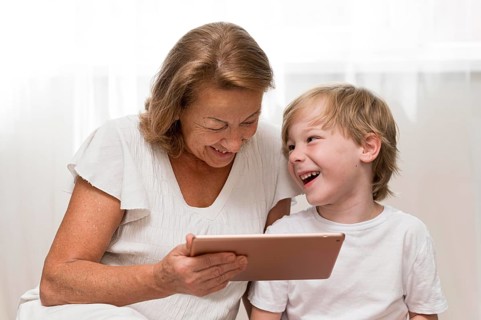 Happy kid grandma with tablet