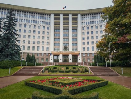 Republic of Moldova parliament building with beautiful garden. Rainy autumn day outdoors