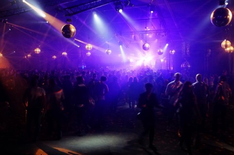 DJ entertaining a crowd in a party tent