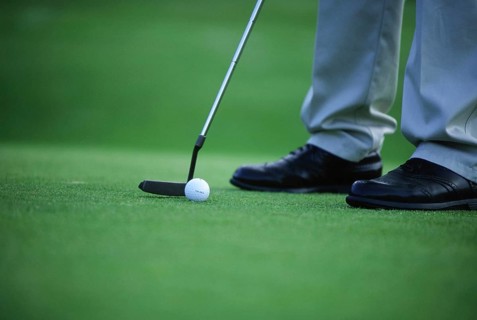 Golfer, tee off on the green, Sweden, Europe