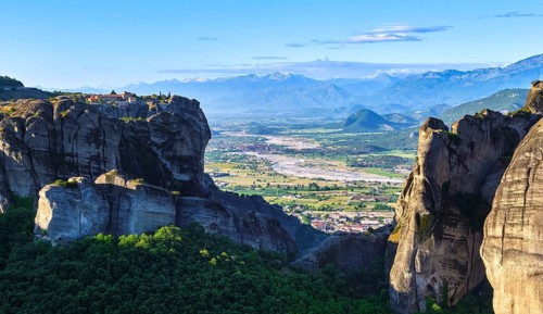 Morning view of monastery of Holy Trinity or Agia Triada on clifftop and rocky pillars. Meteora