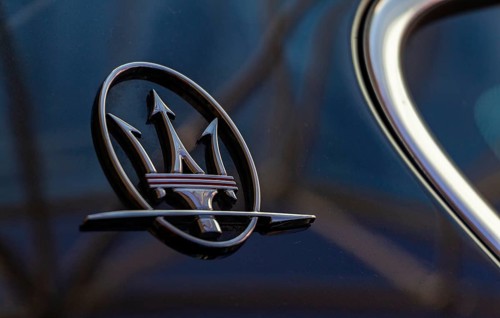 A close-up picture of the Maserati logo on the back of a vehicle