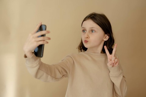 Girl, 10, takes a selfie with mobile phone