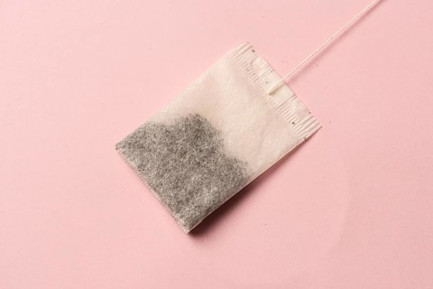 Tea bag on pink background