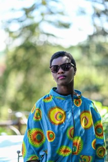 Young adult afro hair diverse black model pose outdoors in african print attire wear sunglasses