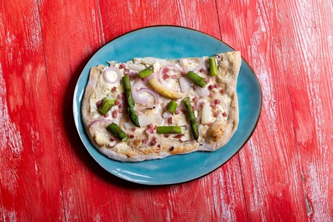 French tarte flambee on red wood