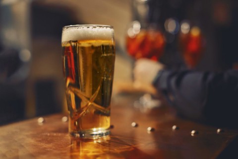 Pint of beer at the bar in a traditional pub. close up