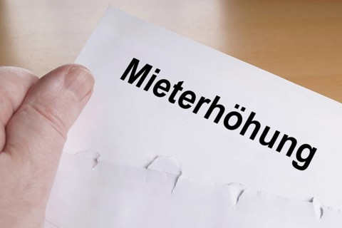 Mieterhöhung is German for rent increase, hand holding letter