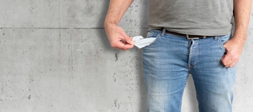 midsection of man turning his empty pockets inside out, having no money and being broke concept