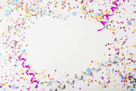 Colorful confetti curling streamers white background with space text. Resolution and high quality