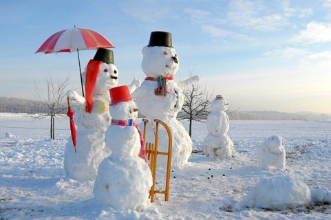 Snowman Family with animal figures, winter landscape Snowman Family with animal figures, winter