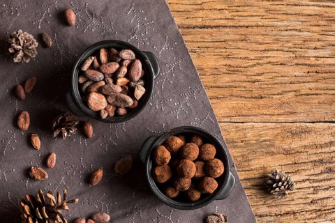 Top view cocoa beans chocolate truffles bowls