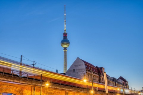 The famous TV tower in Berlin at dusk with a motionless S-Bahn train