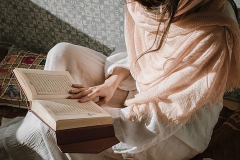Sitting woman reading quran. Resolution and high quality beautiful photo