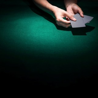Person hand s holding poker card