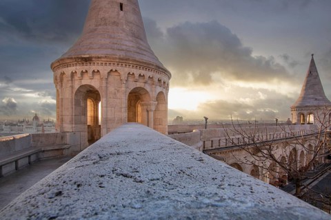 Old historic fortress and church at sunrise. City panorama at dusk. View of the Danube Fishermen's