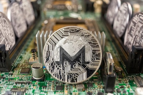 Monero coin close-up on a computer circuit motherboard as a blockchain technology payment network.