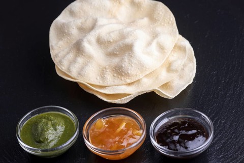 Papadam with various Indian sauces