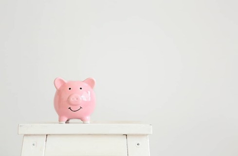 Pink pig piggy Bank on a white background with copy space