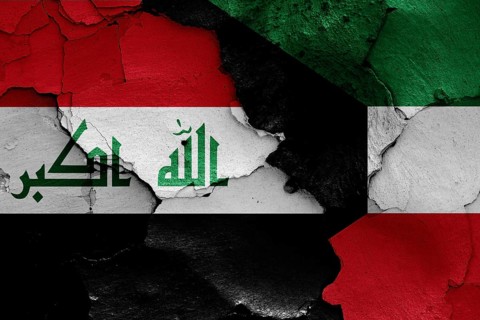 Flags of Iraq and Kuwait painted on cracked wall