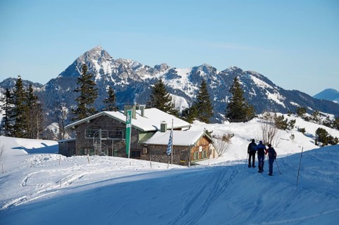Taubensteinhaus with snowshoe hiker, behind Wendelstein, winter, snow, Spitzingsee, Mangfall